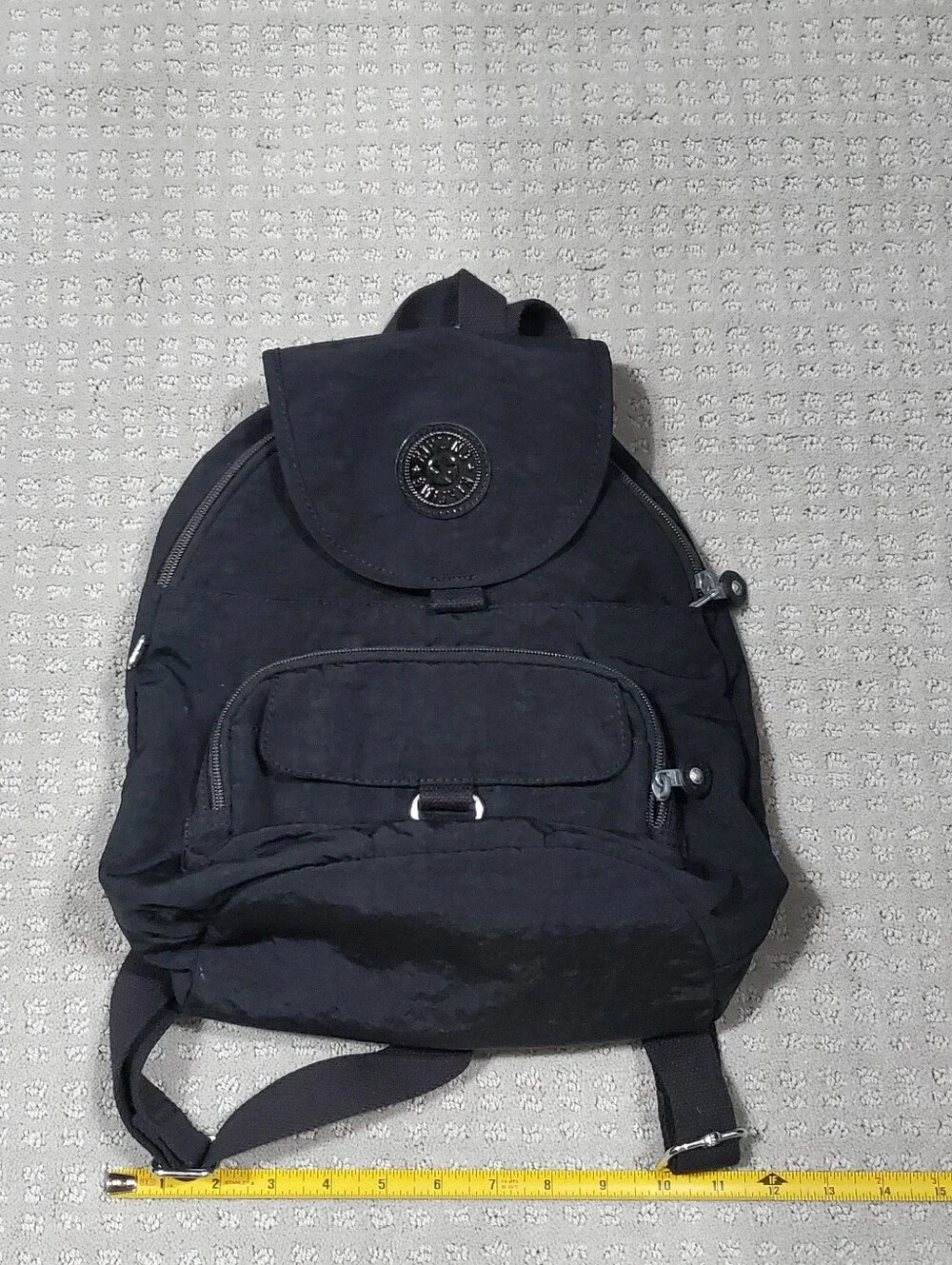 Kipling Queenie Small Backpack Black Nylon Brand Logo on the front flap.